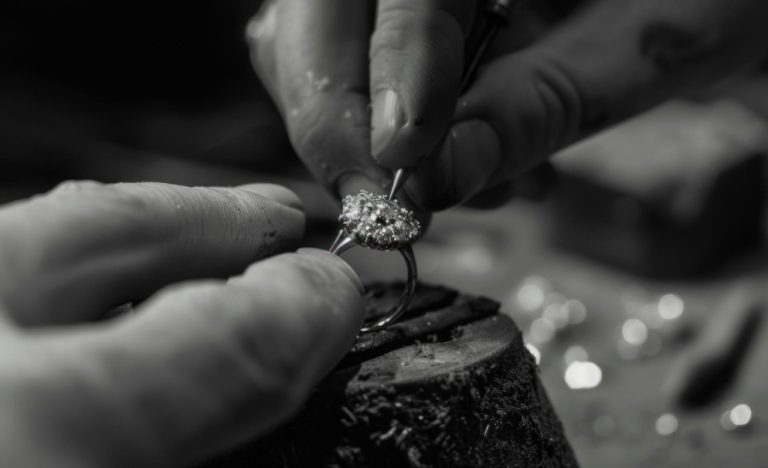 Jeweller sketching a bespoke engagement ring design at a workbench, Singapore atelier