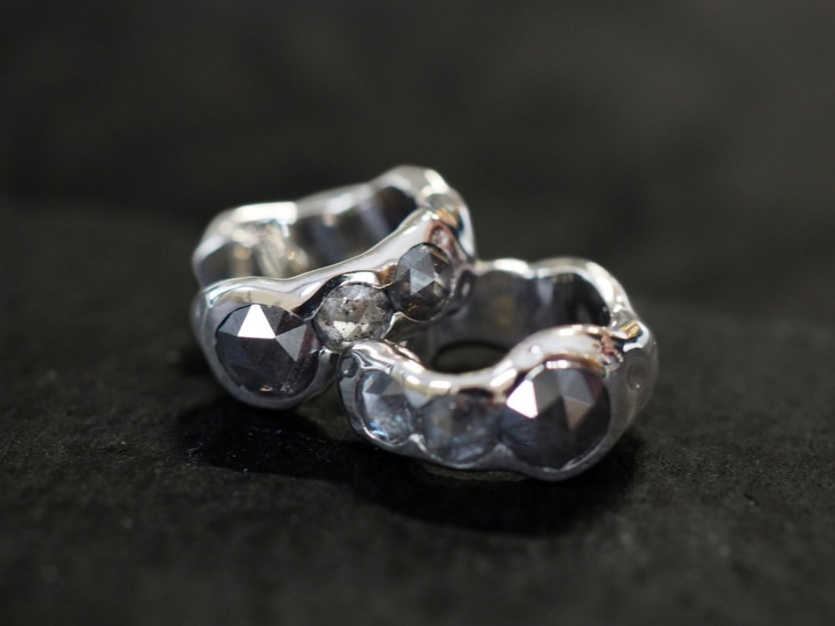 Close-up of two crafted wedding bands with a shared engraving detail, Singapore atelier